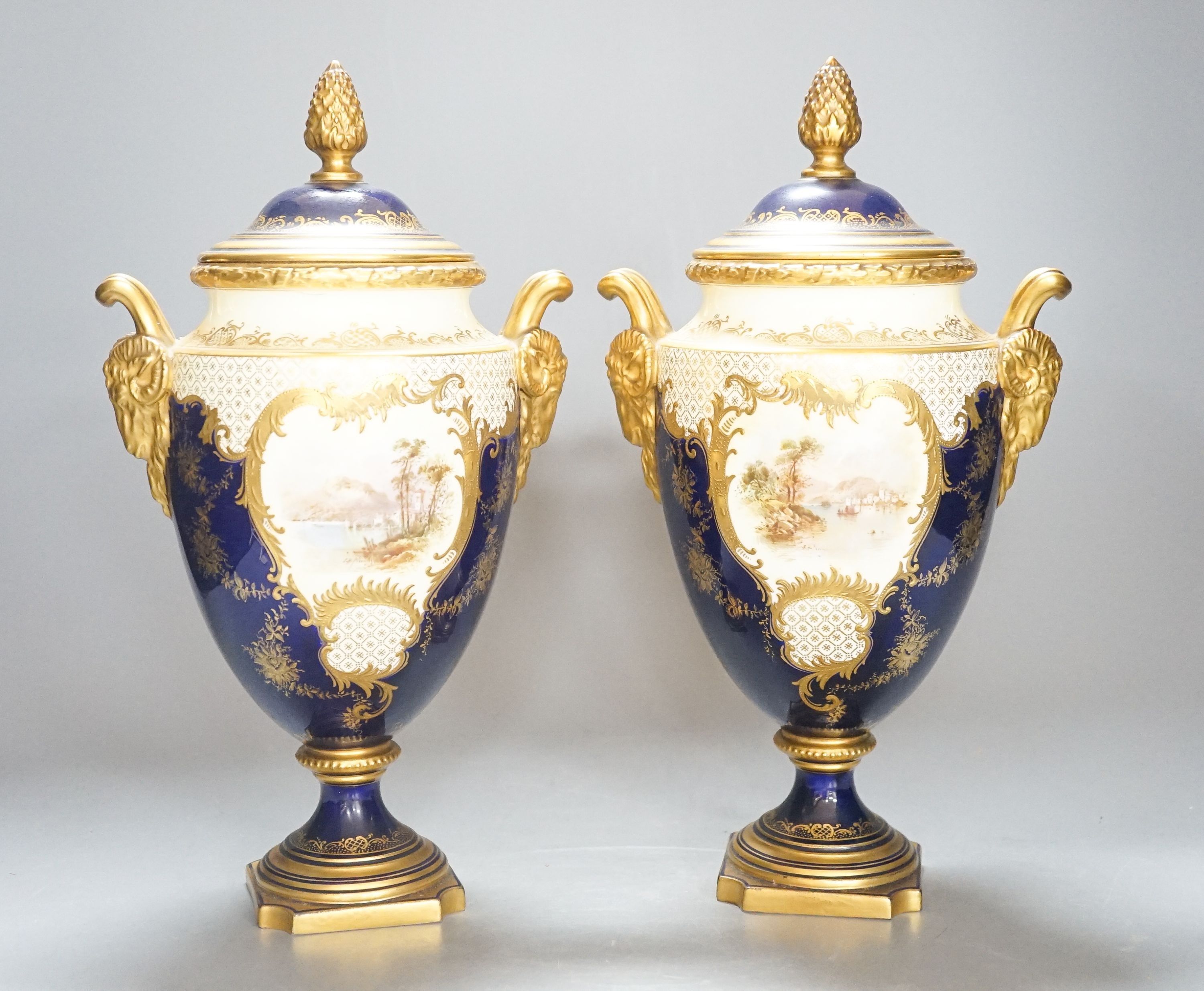 A pair of large Coalport landscape painted vases and covers, c.1900, 30cm